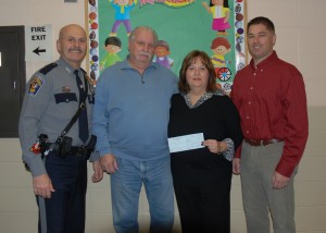 From left to right: Patrolmen Douglas Higgins, John McGuire and Paul Bachovchin present a donation to Regional Day School Transition Coordinator Renee Agro during a recent visit to the school. 